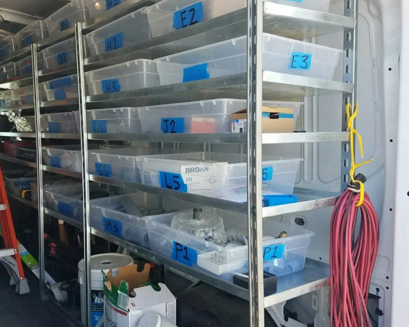 Rows of clear labeled storage boxes on sturdy shelves